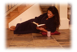 Woman reading on warm tile floor.